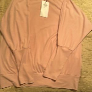 Pink colored off the shoulder long sleeve shirt.